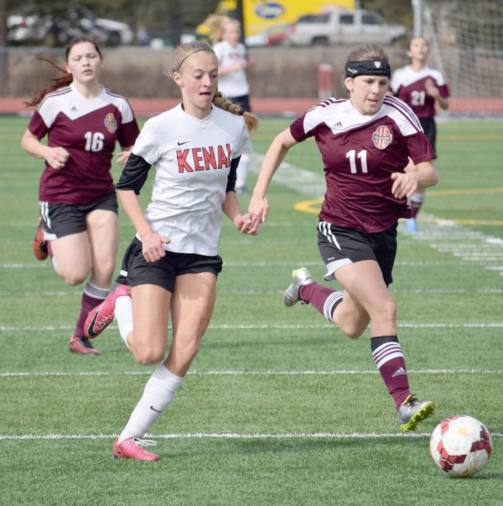 Kenai Central&rsquo;s Samantha Morse and Ketchikan&rsquo;s Neva Garner race for the ball Wednesday, April 26, 2017, at Kenai Central High School. (Photo by Jeff Helminiak/Peninsula Clarion)