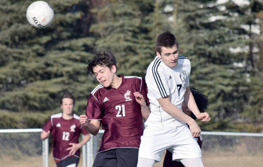 Ketchikan&rsquo;s Colin Whitesides and Kenai Central&rsquo;s Avery Hieber attempt to head the ball Wednesday, April 26, 2017, at Kenai Central High School. (Photo by Jeff Helminiak/Peninsula Clarion)
