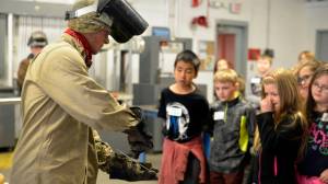 Connor McKamy, a graduate of the Kenai Peninsula College&rsquo;s welding program, shows fourth-graders from Mountain View Elementary an example of the work he does. (Kat Sorensen/Peninsula Clarion)