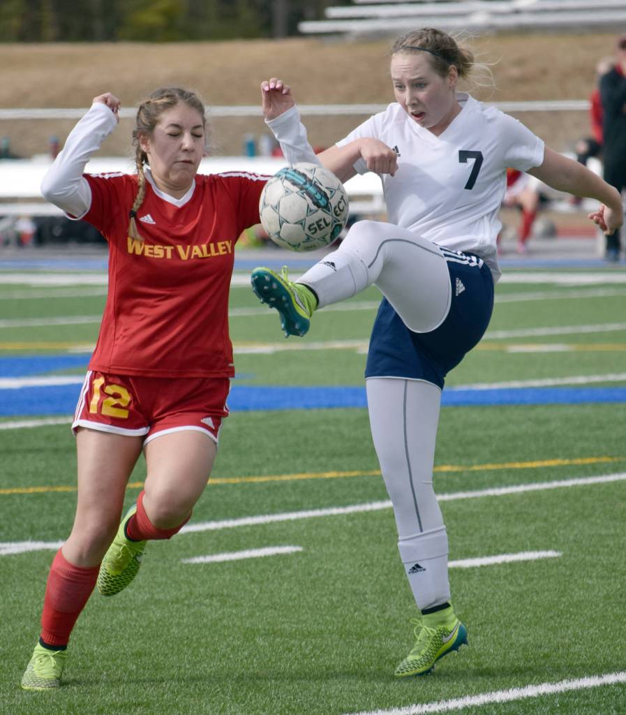 West Valley&rsquo;s Alyssa Mandich runs through the ball as Soldotna&rsquo;s Journey Miller volleys the ball to safety Friday, April 28, 2017, at Soldotna High School. (Photo by Jeff Helminiak/Peninsula Clarion)