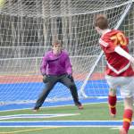 Soldotna goalie Chase Miller defends a cross in front of his goal by West Valley&rsquo;s Seth Thomas on Friday, April 28, 2017, at Soldotna High School. (Photo by Jeff Helminiak/Peninsula Clarion)