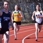 Seward junior Emma Moore races alongside Kenai Central freshman Chelsea Plagge in the girls 400-meter dash Saturday at the Homer Invite at Homer High School. (Photo by Joey Klecka/Peninsula Clarion)