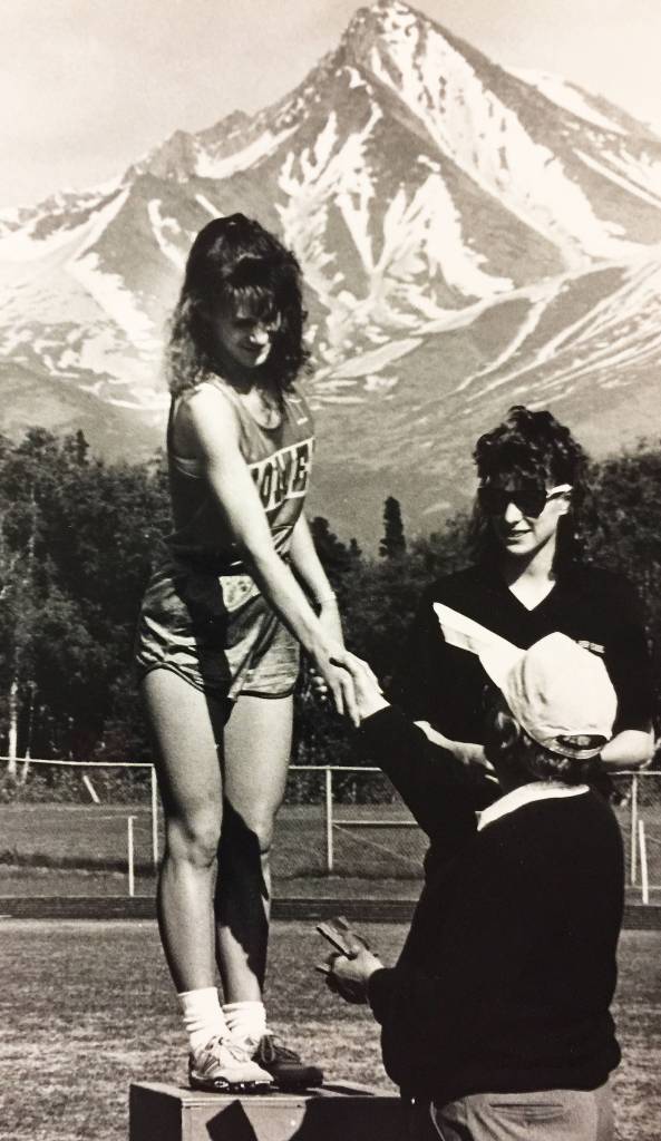 Homer runner Beth Ladd accepts the winner&rsquo;s award at a track and field meet in 1990. (Photo courtesy Beth Ladd)