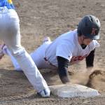 Kenai Central&rsquo;s Zack Selinger avoids the tagout of Kodiak first baseman Louie Rocheleau Thursday night at the Kenai Little League fields. (Photo by Joey Klecka/Peninsula Clarion)