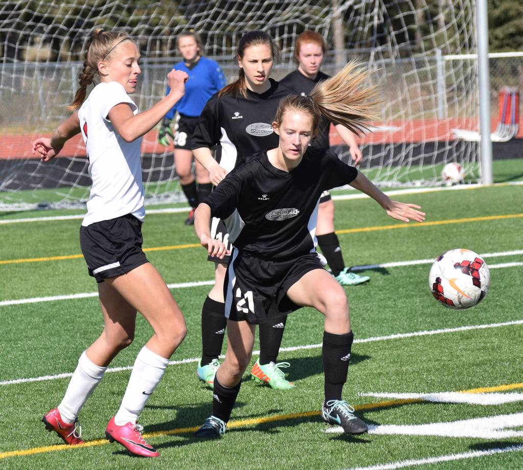 Kenai Central&rsquo;s Samantha Morse vies for the ball against Nikiski&rsquo;s Molly Cason (21) Friday afternoon at Ed Hollier Field in Kenai. (Photo by Joey Klecka/Peninsula Clarion)