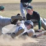 Soldotna&rsquo;s Jeremy Kupferschmid slides safely to home plate to tie the game while Colony pitcher Trace Severson looks on, Tuesday afternoon at the Soldotna baseball fields. (Photo by Joey Klecka/Peninsula Clarion)