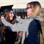 LeAnna Hobby, right, adjusts Allison Bushnell&rsquo;s cap before taking photos following the Kenai Peninsula College graduation Thursday, May 11, 2017 at Ren&