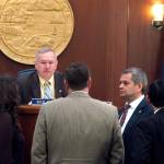 Several Alaska state representatives gather in front of state House Speaker Bryce Edgmon during a break in a House floor session on Wednesday, May 17, 2017, in Juneau, Alaska. (AP Photo/Becky Bohrer)