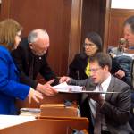 Several Alaska state representatives gather around Rep. Lance Pruitt, seated, during a break in a House floor session on Wednesday, May 17, 2017, in Juneau, Alaska. Shown are, from left, Reps. Tammie Wilson, Steve Thompson, Jennifer Johnston, Pruitt and Chuck Kopp. (AP Photo/Becky Bohrer)