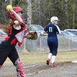 Soldotna&rsquo;s Tara Lynn Frates (11) takes a look behind as Kenai Central catcher Alyssa Stanton makes a throw to first base Wednesday at the Soldotna Little League Fields. (Photo by Joey Klecka/Peninsula Clarion)