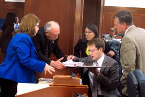 Several Alaska state representatives gather around Rep. Lance Pruitt, seated, during a break in a House floor session on Wednesday, May 17, 2017, in Juneau, Alaska. Shown are, from left, Reps. Tammie Wilson, Steve Thompson, Jennifer Johnston, Pruitt and Chuck Kopp. (AP Photo/Becky Bohrer)
