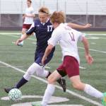 Soldotna&rsquo;s Gavin Goggia tries to move the ball away from Grace Christian&rsquo;s Miles Belanger during the Northern Lights Conference Championships boys&rsquo; quarterfinals Thursday, May 18, 2017, at Colony High School. (Photo by Jeremiah Bartz/Frontiersman.com)