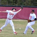 Kenai Central outfielders Ryan Johnson (left) and Jonathan Delgado drop a flyball from Grace Christian, Friday evening at the Kenai Little League Fields. (Photo by Joey Klecka/Peninsula Clarion)