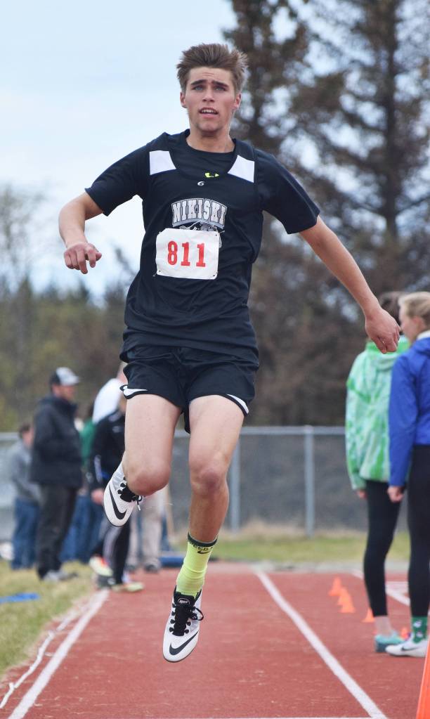 Nikiski&rsquo;s Garrett Ellis flies through the boys triple jump Saturday at the Region III track & field championships in Homer. (Photo by Joey Klecka/Peninsula Clarion)