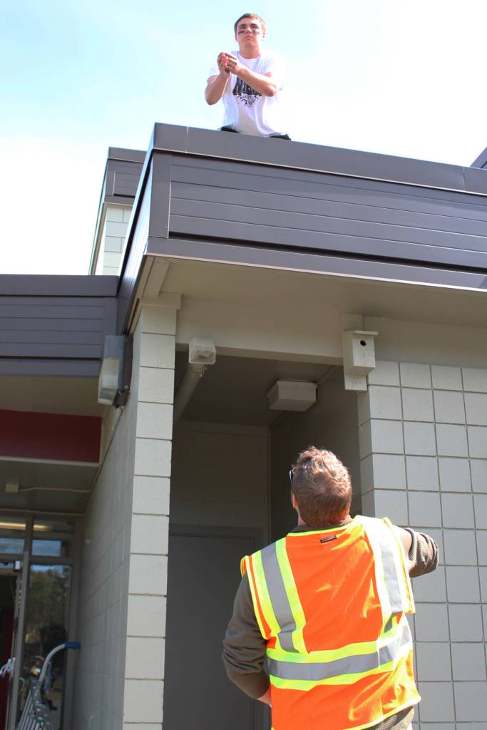 Sam Tauriainen, 19, catches a pair of ear plugs tossed up to him by a drill coordinator before taking part in an active shooter scenario Saturday, May 20, 2017 at the North Peninsula Recreation Center in Nikiski, Alaska. Tauriainen and about 16 other volunteers posed as shooters and wounded victims throughout four different drills while local emergency medical services and law enforcement members were tested on working together during an exercise put on by Las Vegas-based JTM Training Group. (Megan Pacer/Peninsula Clarion)