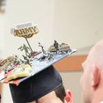 Graduates of Nikiski Middle-High School spared no expense when it came to decorating their caps for their Tuesday, May 23, 2017 ceremony at the school in Nikiski, Alaska. Clayton Larson&rsquo;s hat, pictured here, is adorned to represent his path to the U.S. Army following graduation. (Megan Pacer/Peninsula Clarion)