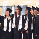 From left to right: Desmeranda Napoka, Ayla Pitt, Brianna Vollertsen, Madison Williams and Sofie Nielsen pose for a quick picture before walking in their graduation ceremony Tuesday, May 23, 2017 at Nikiski Middle-High School in Nikiski, Alaska. (Megan Pacer/Peninsula Clarion)