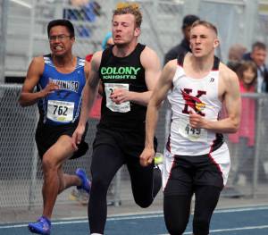 Kenai Central&rsquo;s Josh Jackman, right, stays just ahead of Colony&rsquo;s Jon Pomrenke during the boys&rsquo; 100 meters preliminaries on the first day of the ASAA/First National Bank State Track and Field Championships Friday at Palmer High School. (Photo by Jeremiah Bartz/Frontiersman.com)