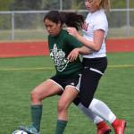 Colony&rsquo;s Kira Fagerstrom (left) battles for possession against Kenai Central&rsquo;s Liz Hanson in a consolation semifinal Friday at the girls state soccer tournament at Eagle River High School. (Photo by Joey Klecka/Peninsula Clarion)
