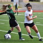 Kenai Central&rsquo;s Cassi Holmes reverses course against Colony&rsquo;s Autumn Richardson in a consolation semifinal Friday at the girls state soccer tournament at Eagle River High School. (Photo by Joey Klecka/Peninsula Clarion)