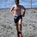 Travis Mabe climbs up the final hill from the beach to Cannery Loop Road on Monday, May 29, 2017, to win the men&rsquo;s 10-mile run at the Mouth to Mouth Wild Run and Ride. (Photo by Jeff Helminiak/Peninsula Clarion)