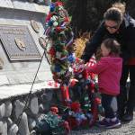 Jane Reynolds teaches 22-month-old Sara to remember the fallen.