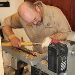 Wood turner Sterling Rasmussen demonstrates bowl turning at KVCC Summer Exhibit opening.