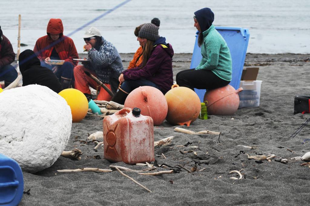 Lawson Alexson-Walls (left) and Beatrix McDonough, both students at West Homer Elementary School, take a break from gathering trash on a beach on Sunday, June 4, 2017 on Augustine Island, Alaska. Both girls participated in a trip coordinated by the Center for Alaskan Coastal Studies to clean debris from the island’s coasts. (Photo by Elizabeth Earl/Peninsula Clarion)