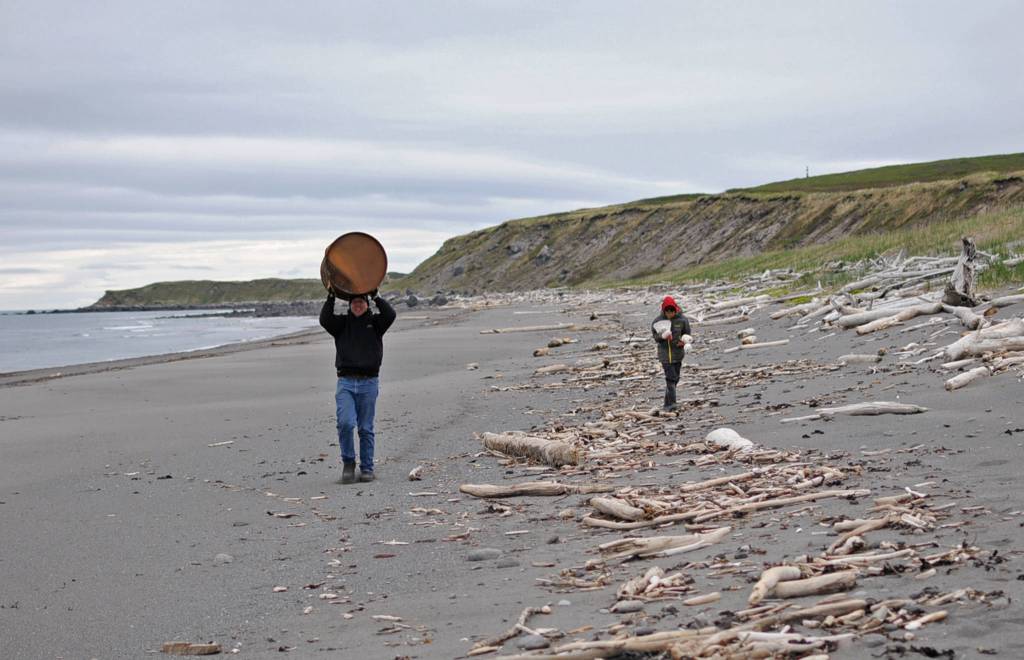 Derek Bynagle (left) and his son Johannes Bynagle of Homer carry marine debris they gathered back to a central camp on a small island near Augustine Volcano on Monday, June 5, 2017 on Augustine Island, Alaska. The Bynagles participated in a trip organized by the Center for Alaskan Coastal Studies to clean marine debris off the beaches of the remote island. (Photo by Elizabeth Earl/Peninsula Clarion)&nbsp;