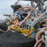 Johannes Bynagle (left) and Gautoma Iwamura, both homeschool students through the Kenai Peninsula Borough School District Connections program, tug a makeshift sled loaded with marine debris down the beach on Sunday, June 4, 2017 on Augustine Island, Alaska. The two were participants in a trip organized by the Homer-based nonprofit Center for Alaskan Coastal Studies to clean up debris along the beaches of the remote island in Cook Inlet. (Photo by Elizabeth Earl/Peninsula Clarion)