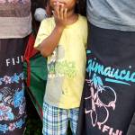 A Waitabu boy hides behind his mother and aunt while the village sings Isa Lei, their traditional Fijian farewell song. (Photo courtesy Tracy Melvin)