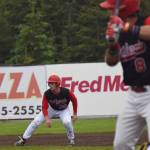 Mikey Hoehner watches intently as Peninsula Oilers teammate Matt Acosta takes a pitch from the Mat-Su Miners Friday night at Coral Seymour Memorial Park in Kenai. (Photo by Joey Klecka/Peninsula Clarion)