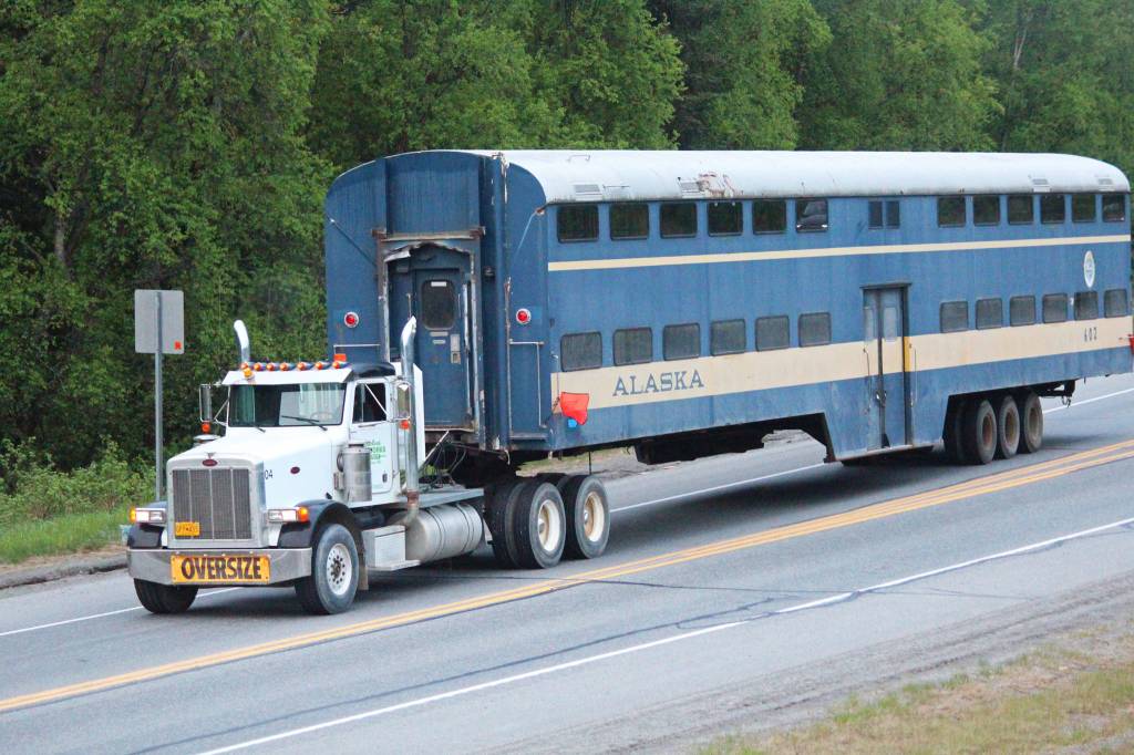 From left to right: Henry Krull, Elan Krull, Alyeska Krull and Mary Krull talk excitedly as they watch a former Alaska Railroad rail car being towed into place Saturday, June 3, 2017 on Kleeb Loop in Soldotna, Alaska. Mary Krull plans to turn rail car 602, along with another car from South Dakota, into a coffee house and a beer and wine bar/restaurant, respectively. (Megan Pacer/Peninsula Clarion)