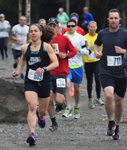 Women&rsquo;s Run for the River 10-mile runner-up Heather Moon (609) leads a pack of racers out onto the course Saturday morning in Soldotna, with women&rsquo;s 10-mile race winner Bethany Tietz (in yellow shirt) following closely. (Photo by Joey Klecka/Peninsula Clarion)