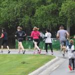 The field of Run for the River 5-kilometer racers stream out onto the course Saturday morning in Soldotna. (Photo by Joey Klecka/Peninsula Clarion)