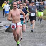 Men&rsquo;s Run for the River 10-mile winner Matt Adams leads the pack out onto the course Saturday morning in Soldotna. (Photo by Joey Klecka/Peninsula Clarion)