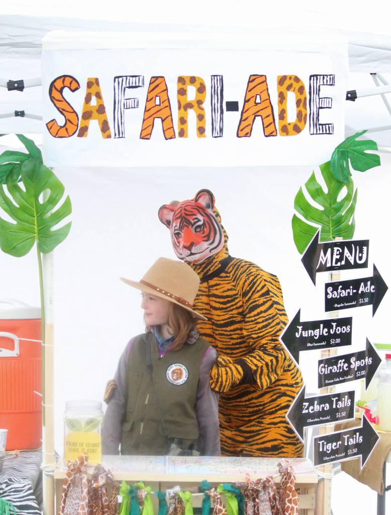 Sara Hondel helps Truly Hondel, 8, with her lemonade stand just down the street from the Kenai River Festival on Saturday, June 10, 2017 in Soldotna, Alaska. The pair opened at 11 a.m. for Lemonade Day, an annual learning program in which youngsters are taught about entrepreneurship, and reported a pretty steady flow of customers. (Megan Pacer/Peninsula Clarion)