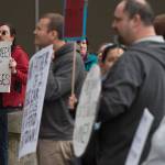 Tony Warren, a state employee at the Department of Education and Early Development, left, stands with other state workers during noon rally against the Legislature&rsquo;s lack of a budget on Thursday, June 22, 2017. (Michael Penn | Juneau Empire)