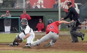 Peninsula Oilers catcher Mikey Hoehner prepares to tag out Levi Gilcrease of the Chugiak-Eagle River Chinooks for the first out in the ninth inning Friday, June 30, 2017, at Coral Seymour Memorial Park in Kenai. Gilcrease would have been the tying run in the Oilers&rsquo; 4-3 victory. (Photo by Jeff Helminiak/Peninsula Clarion)