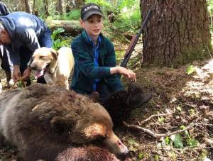 Elliot Clark and family with a brown bear he shot after it charged a group of hunters near Hoonah. (Photo courtesy Sen. Shelly Hughes&rsquo; Facebook page)