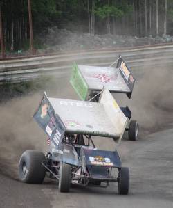 Sprint car racers slide around the turns Saturday night at Twin City Raceway in Kenai. The highlight of the weekend was the &ldquo;Filthy Fifty&rdquo; feature race Saturday night, which pitted A- and B-Stock racers against each other for 50 laps. Racing resumes today at 1 p.m. (Photo by Joey Klecka/Peninsula Clarion)