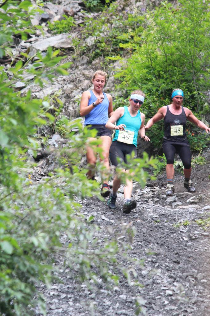 Three runners in the Mount Marathon Race speed down to the mountain&rsquo;s base Tuesday, July 4, 2017 in Seward, Alaska. (Photo by Megan Pacer/Peninsula Clarion)