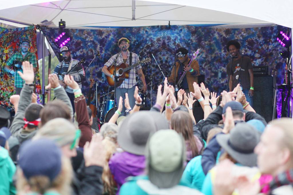Audience members clap along to the Blackwater Railroad Company&rsquo;s afternoon performance Aug. 7, 2016 at Salmonfest 2016 in Ninilchik, Alaska. Photo by Kelly Sullivan/ Peninsula Clarion