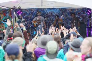 Audience members clap along to the Blackwater Railroad Company&rsquo;s afternoon performance Aug. 7, 2016 at Salmonfest 2016 in Ninilchik, Alaska. Photo by Kelly Sullivan/ Peninsula Clarion