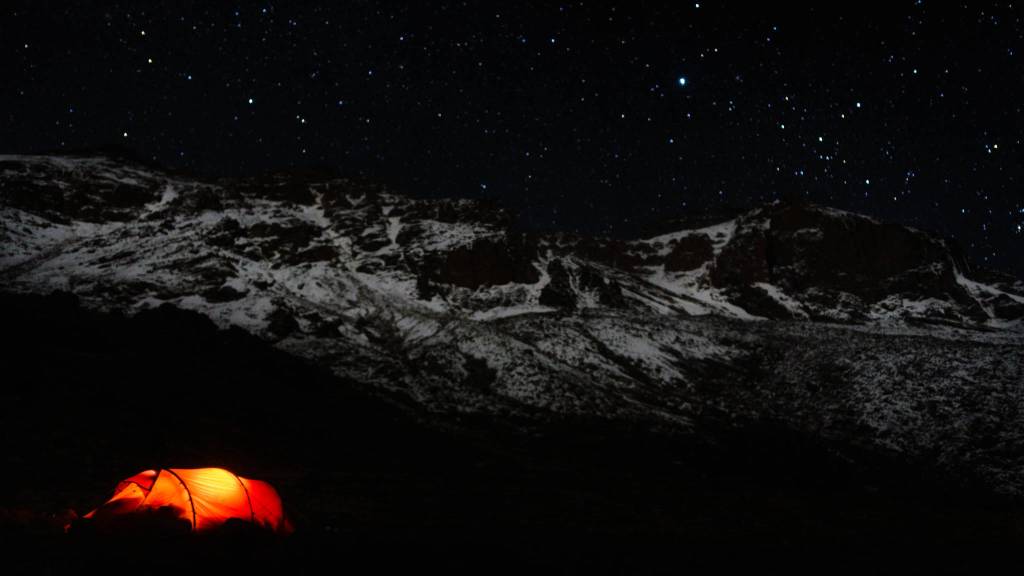 Chris Walden&rsquo;s illuminated tent stands out again the starry night and backdrop of Mt. Kilimanjaro in Tanzania on Jan. 3, 2017. Walden made the expedition up Kilimanjaro with his daughter Avery, then 9, and a family friend in January, making Avery the youngest female to ascend the mountain. (Photo courtesy Chris Walden)