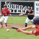 Paul Steffensen watches as Cody Quelland lays down a bunt against South, Saturday at Coral Seymour Memorial Park in Kenai. (Photo by Joey Klecka/Peninsula Clarion)