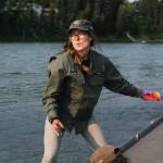 Alice Main, the Stream Watch coordinator for the Kenai Watershed Forum, winds up to throw a chunk of king salmon carcass out into the fast-moving waters of the Kenai River from the Centennial Park disabled angler dock during a &ldquo;stop, chop and throw&rdquo; demonstration of how to properly dispose of fish carcasses Thursday, July 13, 2017 in Soldotna, Alaska. (Photo by Elizabeth Earl/Peninsula Clarion)