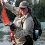 Kathy Heindle, a Kenai Peninsula Stream Watch volunteer, holds up a filleted king salmon carcass before demonstrating how to properly &ldquo;stop, chop and throw&rdquo; the carcass into the Kenai River in Centennial Park on Thursday, July 13, 2017 in Soldotna, Alaska. Heindle, who has been volunteering with Stream Watch since 2011, received a &ldquo;Kingmaker&rdquo; award from the Kachemak Heritage Land Trust for her work protecting the Kenai River watershed. (Photo by Elizabeth Earl/Peninsula Clarion)