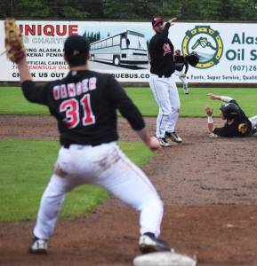 Peninsula Oilers second baseman Ryan Smith lobs a double play throw to first baseman Benjamin Wanger against the Anchorage Bucs Wednesday night at Coral Seymour Memorial Park in Kenai. (Photo by Joey Klecka/Peninsula Clarion) Peninsula Oilers second baseman Ryan Smith lobs a double play throw to first baseman Benjamin Wanger against the Anchorage Bucs Wednesday night at Coral Seymour Memorial Ballpark in Kenai. (Photo by Joey Klecka/Peninsula Clarion)