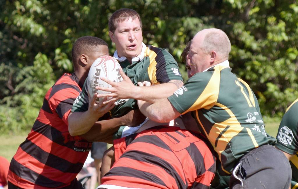 Brian Johnson of Kenai River Wolfpack holds onto the ball as teammate Clay Beck pushes him forward against the Fairbanks Sun Dawgs on Saturday, July 22, 2017, at the Kenai Dipnet Fest Rugby 10s Tournament in Kenai. (Photo by Jeff Helminiak/Peninsula Clarion)